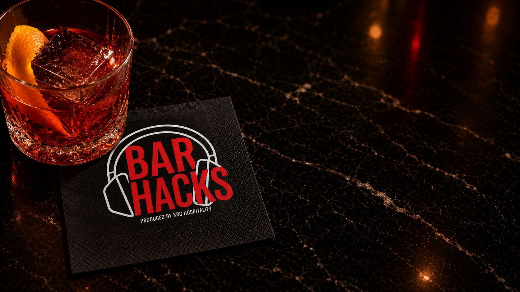 Bar Hacks podcast branding on a premium cocktail napkin in an upscale bar setting.