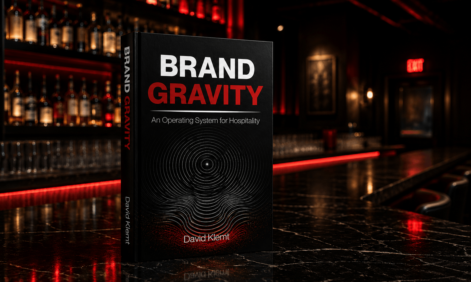 Brand Gravity: An Operating System for Hospitality by David Klemt standing on a marble bar top in an upscale nightlife venue illuminated by red ambient lighting.